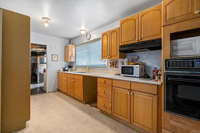 kitchen featuring sink and black oven