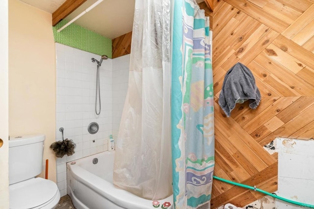 bathroom featuring shower / tub combo with curtain, toilet, and wood walls