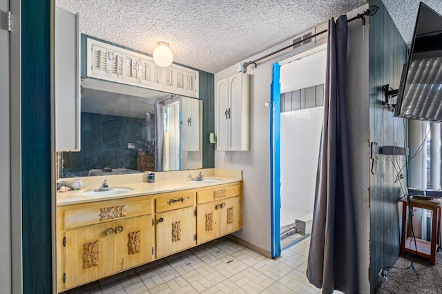 bathroom featuring vanity and a textured ceiling