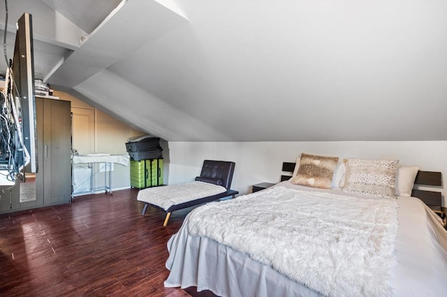 bedroom with dark hardwood / wood-style floors and vaulted ceiling