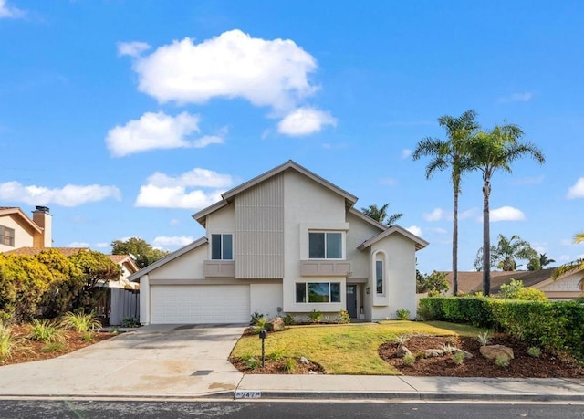 view of front property featuring a garage and a front lawn