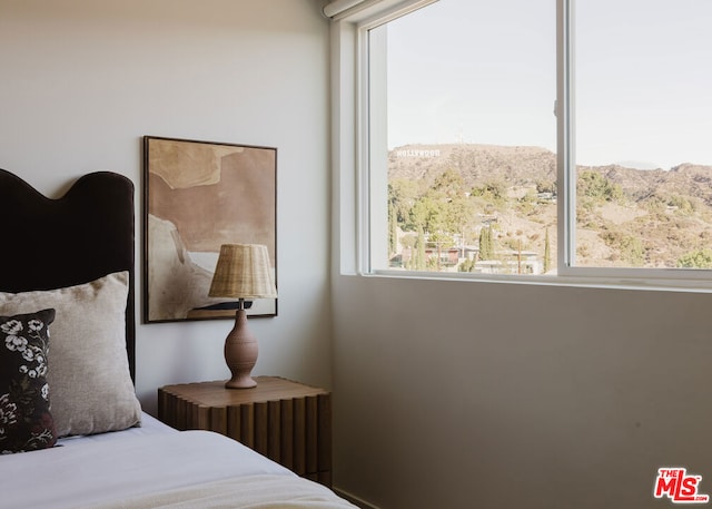 bedroom featuring a mountain view