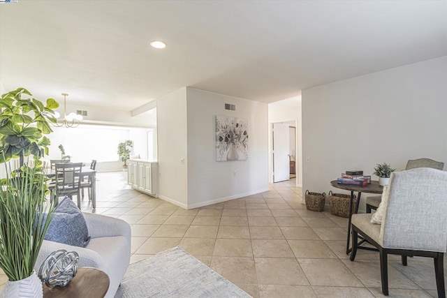 hallway featuring light tile patterned floors and a notable chandelier