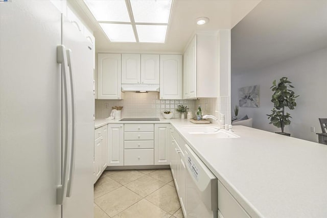 kitchen featuring tasteful backsplash, sink, white cabinets, light tile patterned floors, and white appliances