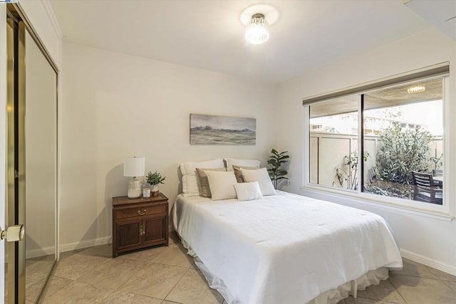 tiled bedroom featuring a closet