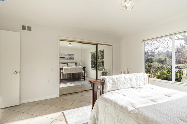 bedroom featuring light tile patterned floors and a closet