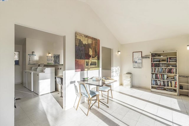 interior space with washing machine and clothes dryer and high vaulted ceiling