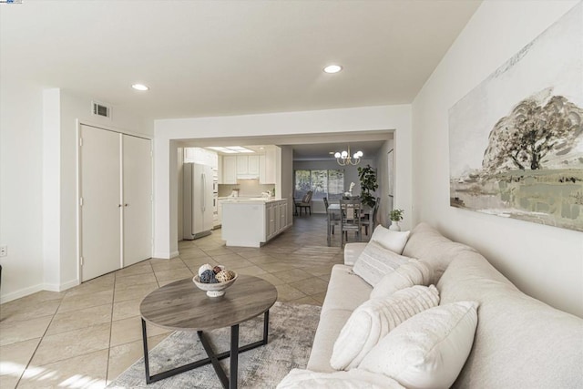 living room with a chandelier and light tile patterned floors