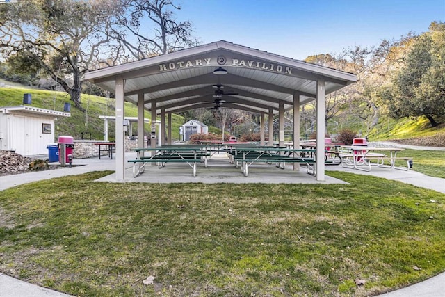 view of home's community featuring a storage shed, a gazebo, and a lawn