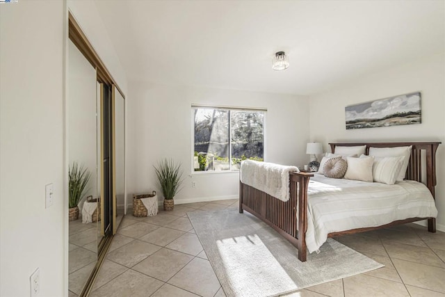 bedroom featuring light tile patterned floors and a closet