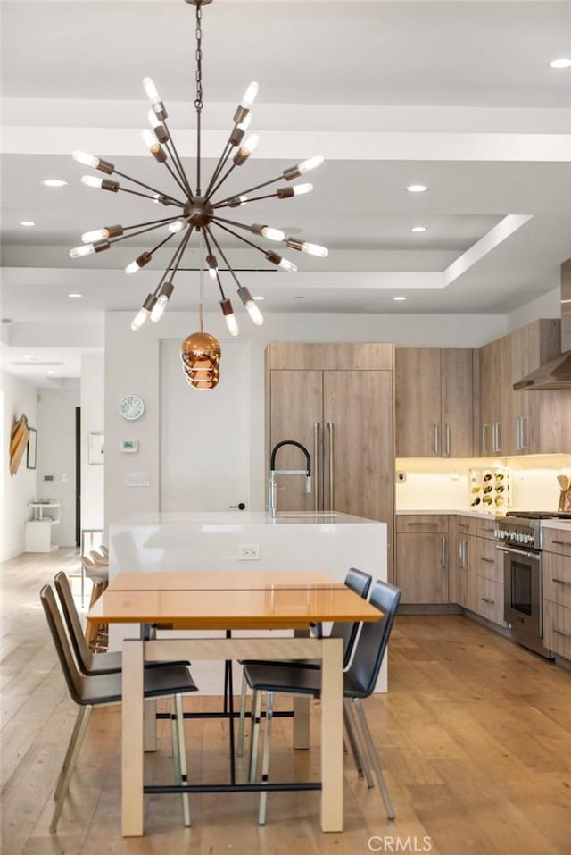 dining area featuring sink and a tray ceiling