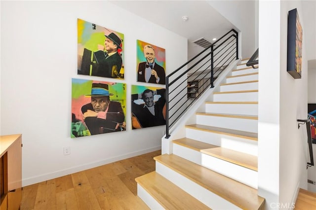 staircase featuring hardwood / wood-style floors