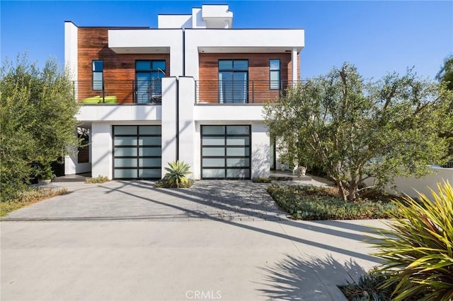 contemporary house with a garage and a balcony