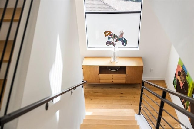 stairs with hardwood / wood-style floors