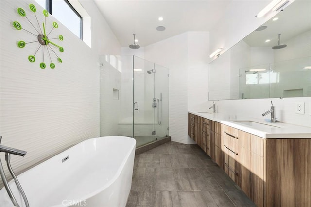 bathroom featuring vanity, shower with separate bathtub, and tile walls