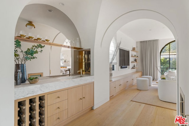 bathroom featuring lofted ceiling, hardwood / wood-style floors, and vanity