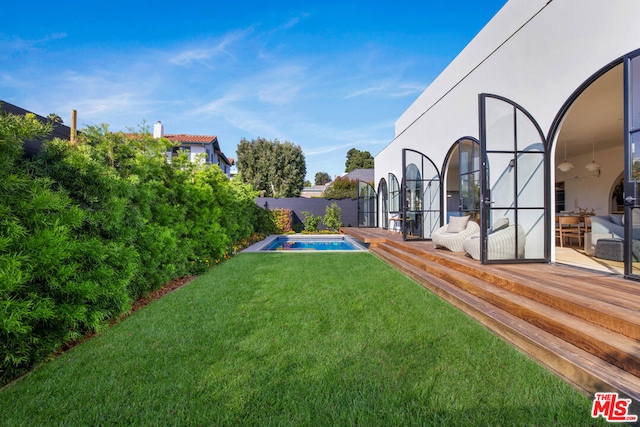 view of yard with a swimming pool side deck and a patio area