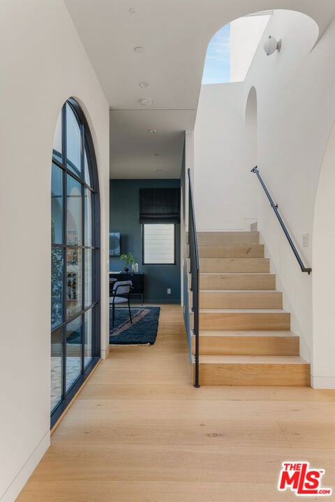 stairs with hardwood / wood-style floors