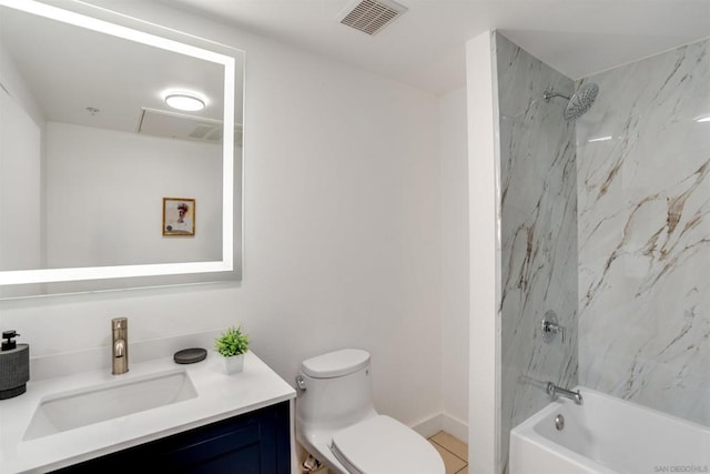 full bathroom featuring vanity, tiled shower / bath combo, and toilet