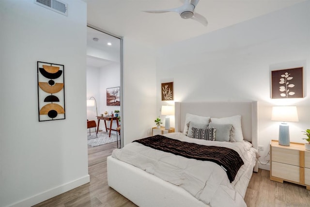 bedroom with ceiling fan and light hardwood / wood-style floors