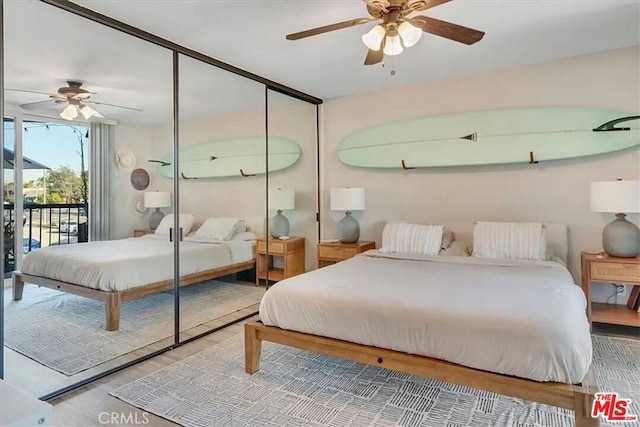 bedroom featuring ceiling fan, wood-type flooring, access to exterior, and a closet