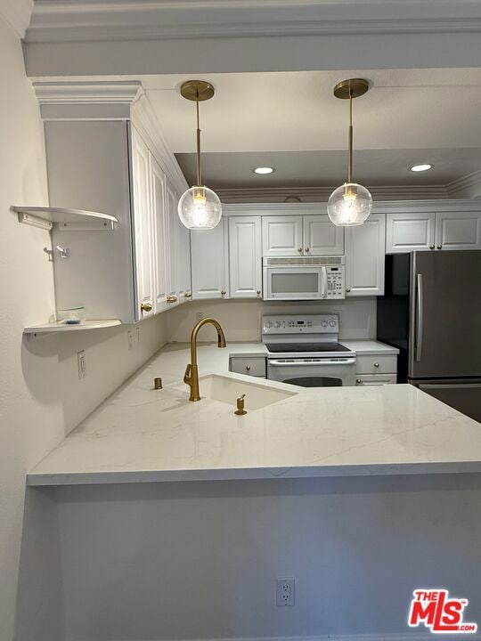 kitchen with white appliances, decorative light fixtures, light stone countertops, and white cabinets