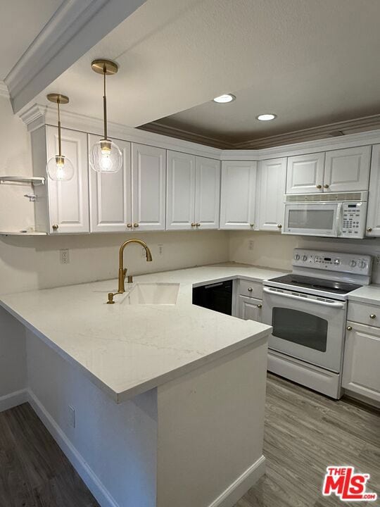 kitchen featuring pendant lighting, white appliances, kitchen peninsula, and white cabinets