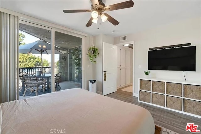 bedroom featuring ceiling fan, access to exterior, and dark hardwood / wood-style flooring