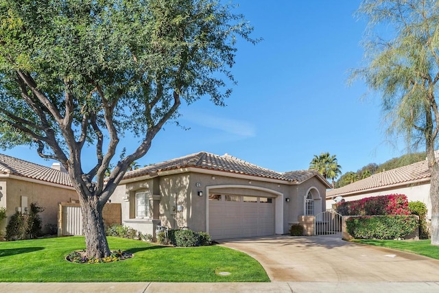 mediterranean / spanish house with a garage and a front yard