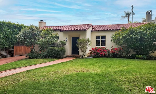 mediterranean / spanish-style home featuring a front lawn