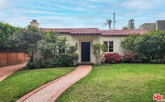 mediterranean / spanish-style house with a front lawn