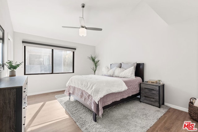 bedroom with lofted ceiling, light hardwood / wood-style flooring, and ceiling fan