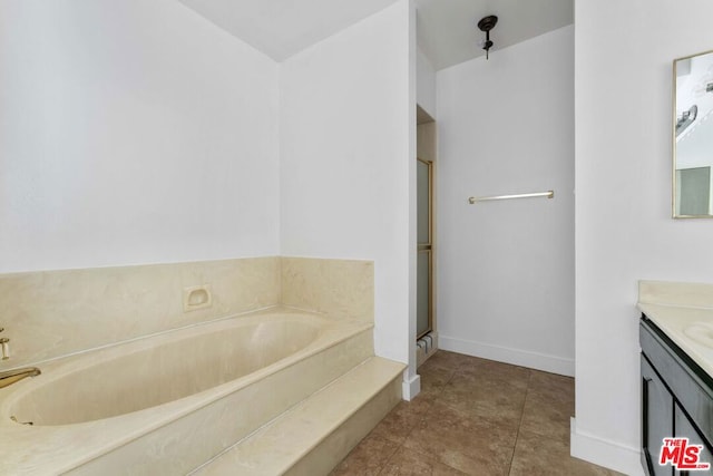 bathroom featuring tile patterned flooring, vanity, and a bathtub