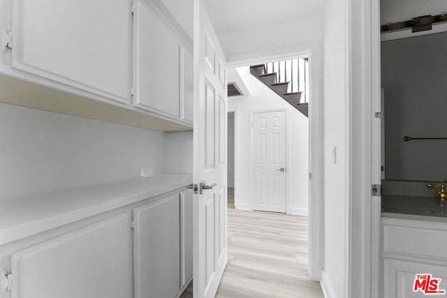 corridor with light hardwood / wood-style flooring