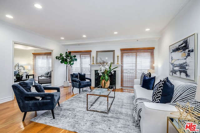 living room with crown molding, hardwood / wood-style flooring, and a healthy amount of sunlight