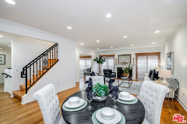 dining space featuring crown molding, plenty of natural light, and hardwood / wood-style floors