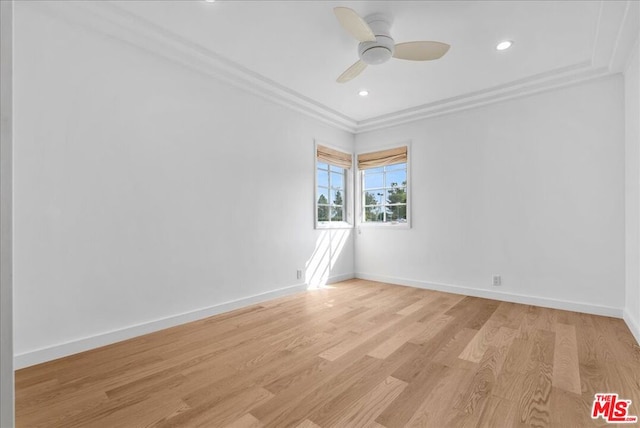 unfurnished room with ornamental molding, ceiling fan, and light wood-type flooring