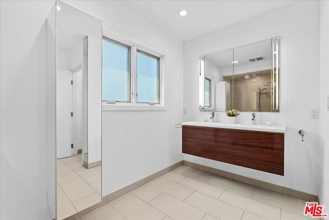 bathroom featuring vanity, an enclosed shower, and tile patterned flooring