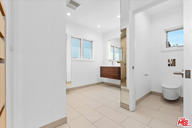 bathroom featuring tile patterned flooring, vanity, plenty of natural light, and toilet