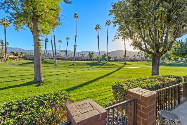 view of property's community with a yard and a mountain view