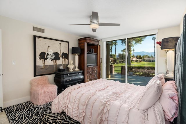 bedroom featuring ceiling fan and access to exterior