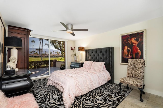 bedroom with access to exterior, light tile patterned floors, and ceiling fan