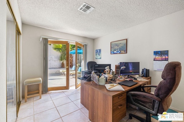 tiled office space with french doors and a textured ceiling