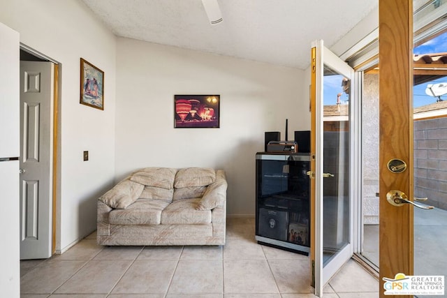 sitting room with lofted ceiling and light tile patterned floors