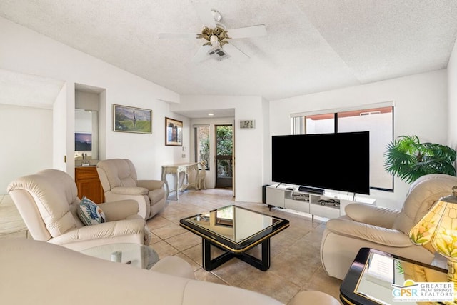 tiled living room featuring ceiling fan and a textured ceiling