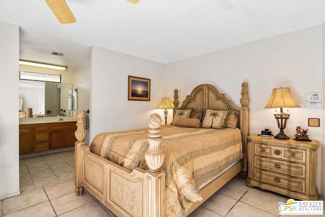 bedroom with sink, ceiling fan, and ensuite bathroom