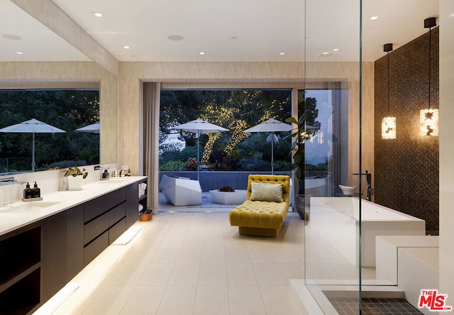 bathroom with vanity, tile patterned flooring, and a bathtub