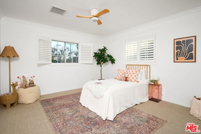 bedroom with ornamental molding, ceiling fan, and carpet