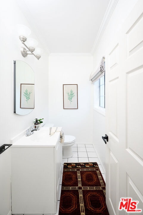 bathroom featuring vanity, tile patterned flooring, ornamental molding, and toilet