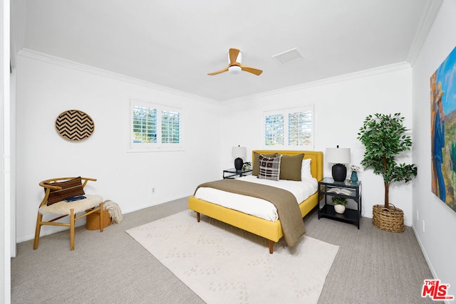 carpeted bedroom with ornamental molding and ceiling fan